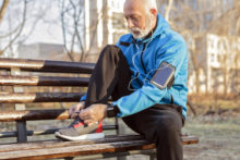 Man tying his shoes before exercising